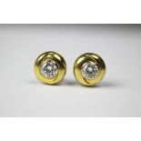 A pair of diamond set stud earrings, each set with a round brilliant cut diamond (each of approx 0.