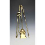 A French brass three piece companion set, with cast geometric detailing to the handles,