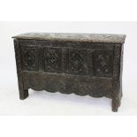 A 17th century and later oak six plank coffer with later carved detailing,