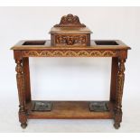 A Victorian carved oak umbrella stand, with drawer and green man handle,