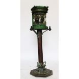 An early 20th century painted ships mast lantern, upon a later stand,