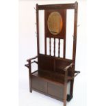 A 1920's oak hall stand with hinged box seat,