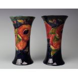 A pair of Moorcroft Pomegranate pattern flared sleeve vases,