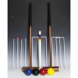 An modern croquet set, with turned wood mallets, in green bag carrier,