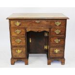 A George III style oak and walnut crossbanded knee hole desk,
