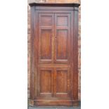 A large George III free standing oak corner cabinet,