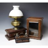 An early 20th century oak smokers cabinet, with bevelled glazed door revealing a fitted interior,