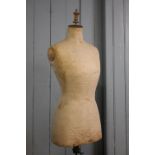 A vintage pine female dressmakers dummy, on adjustable stand and tripod base,