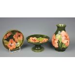 Three pieces of Moorcroft comprising; a pedestal bowl, 9.