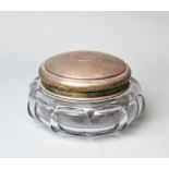 A large Art Deco silver topped powder jar, London 1922, with facet cut body and star cut base, 15.