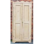 An Edwardian pine hall cabinet, with two panelled doors, (later back panel and hanging shelf),