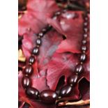 A graduated 'cherry' amber bead necklace, largest 2.8cm wide, smallest 9mm wide, gross weight 58.