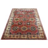A Caucasian machine woven wool carpet, worked with a geometric design in pale colours,