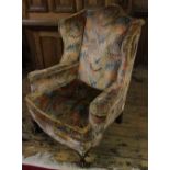 A pair of 1920's Queen Anne style wing back chairs, on cabriole legs with claw and ball feet,