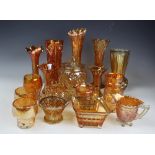 A large selection of marigold carnival glass vases, glasses and jugs including,