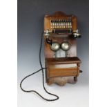 A vintage walnut wall mounted ten extension wind up telephone, NO 393524,