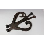 A pair of French wrought iron door brackets, of large proportions,