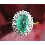 An emerald and diamond cluster ring,