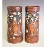 A pair of Japanese carved bamboo vases, Meiji period (1868-1912) depicting Geisha in a garden,