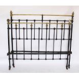 An Edwardian cast iron and brass 4ft 6ins bed,