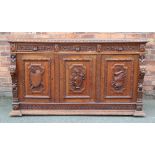 A Victorian carved oak dresser, with three drawers with 'Green Man' handles,