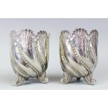 A pair of Victorian silver vases, Birmingham 1891, each of rococo style upon three feet,