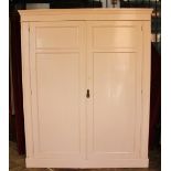 A late Victorian pink painted pine cupboard, with two panelled doors enclosing adjustable shelves,