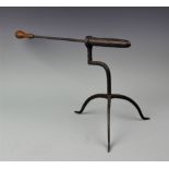 A late 18th century wrought iron goffering iron, on tripod base, with later poker,