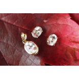 A morganite set pendant and matching stud earrings, the pendant with oval stone in rub-over setting,
