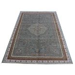 A Kashmir carpet, worked with an all over floral design in panels, against a pale ground,