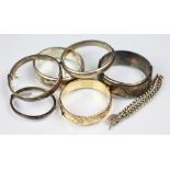 A collection of five silver hinged bangles, a silver babys bracelet,