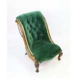 A William IV carved mahogany salon chair, with green upholstery, on scroll legs,