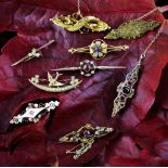 A collection of nine Victorian and later bar brooches, to include stone set, 9ct and 15ct examples,