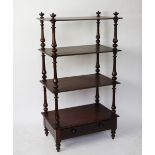 A Victorian mahogany four tier what not, with turned uprights, and base drawer, on turned legs,