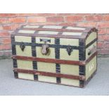 A vintage dome top travelling trunk, with canvas and wooden bound body,