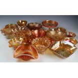 A large selection of marigold carnival glass pedestal bowls, shallow bowls,