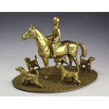 A large brass hunting group of a huntsman on horseback with five hounds, 31cm H x 44.