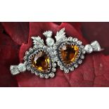 A Charles Horner double heart silver brooch, Chester 1899, designed as two citrine coloured,