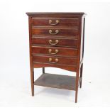 An Edwardian mahogany five drawer music cabinet, on tapered legs,