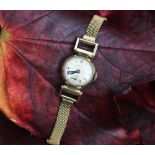 A Rolco 9ct gold ladies wristwatch, the circular face with black Arabic numerals,