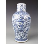 A late 19th century Chinese blue and white vase, Kangxi style, decorated with figures,