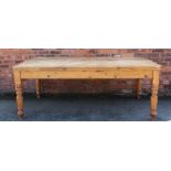 A Victorian style pine farmhouse kitchen table, with scrubbed top on turned legs,