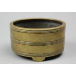 A Chinese bronze circular censer, apocryphal six character Xuande mark, with ribbed detailing,
