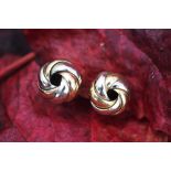 A pair of 9ct bi-colour gold clip earrings, in the form of an entwined garland, gross weight 6.