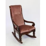 A Victorian mahogany childs rocking chair, with upholstered seat,