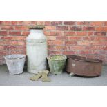 A selection of vintage garden items, comprising a cast iron stove, with a milk churn and cover,