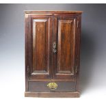 An Edwardian walnut table top cabinet, with two doors and drawer,