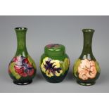 A Moorcroft bottle shaped vase decorated with purple Hibiscus blooms, 16cm high,