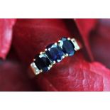 A sapphire and diamond set dress ring, the three central oval sapphires,