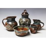 A collection of Juliet Beaumont studio pottery wares comprising; a set of three graduated jugs,